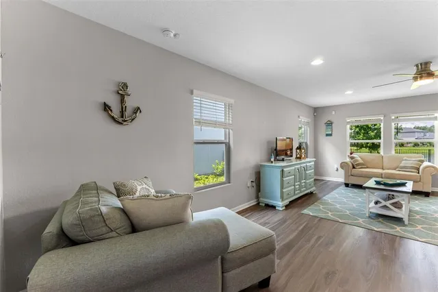 a living room with furniture and a wooden floor