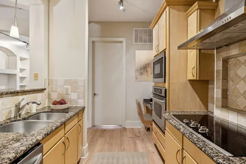 a kitchen with sink a stove and refrigerator