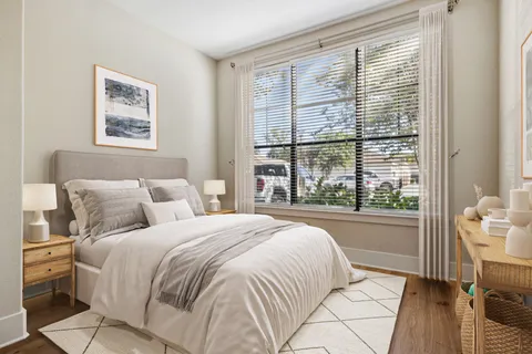 a bedroom with a large bed and a window