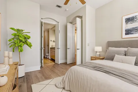 a bedroom with a bed and a potted plant