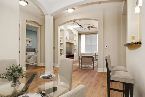 a living room with furniture a table and chairs