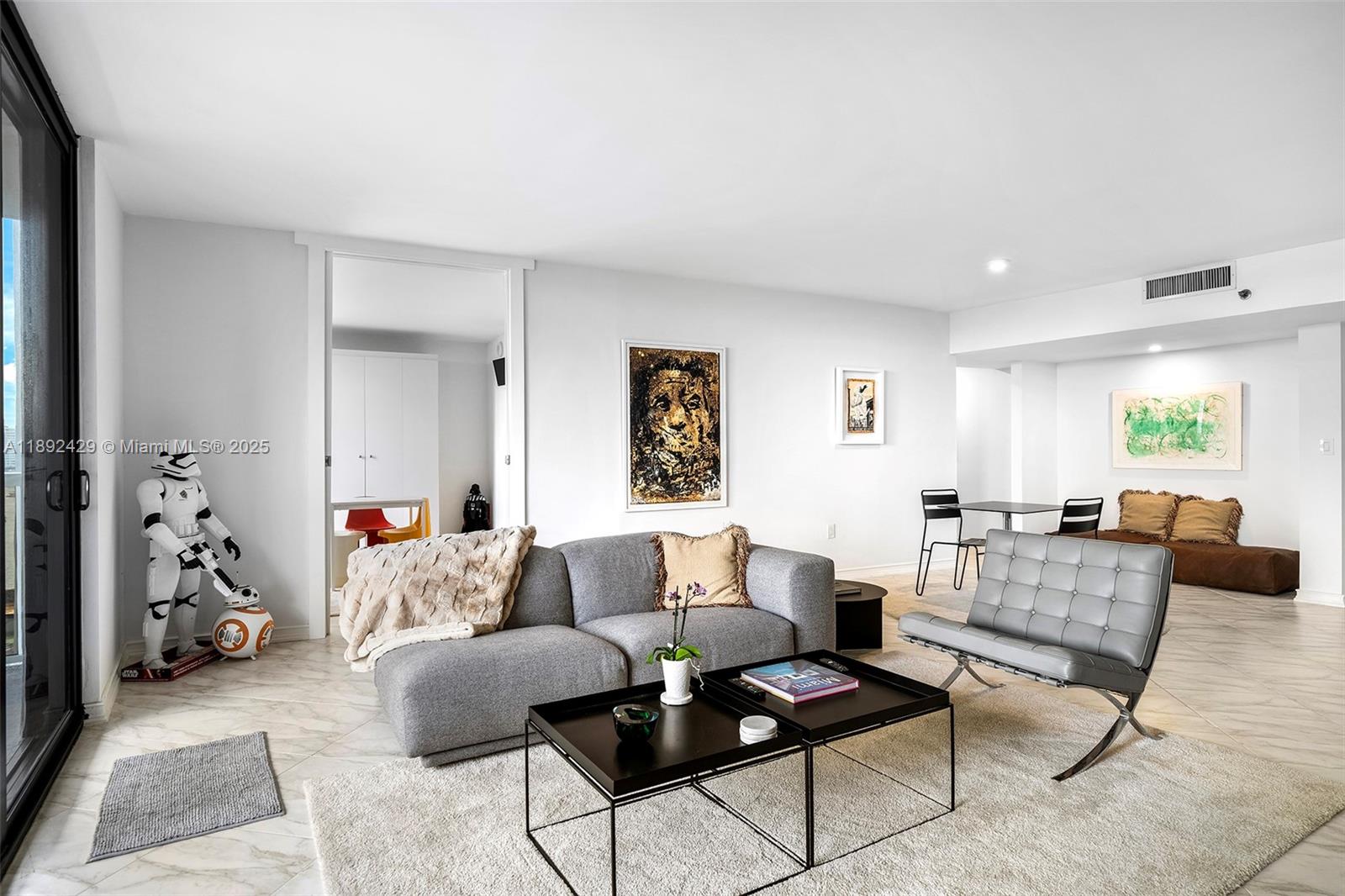 9 Island Avenue, Unit 710 Miami Beach, FL 33139 - Photo 2 of 15 a living room with furniture and a flat screen tv