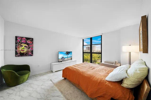 a bedroom with a bed and a couch