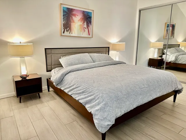 a bed room with a bed and a night stand