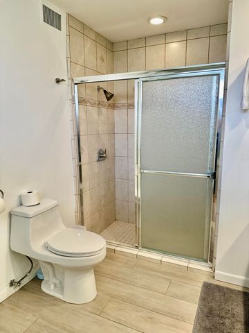 a bathroom with a toilet and a shower