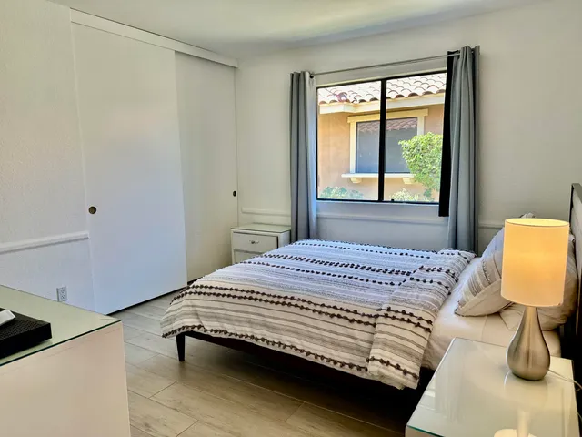 a bedroom with a bed and a window