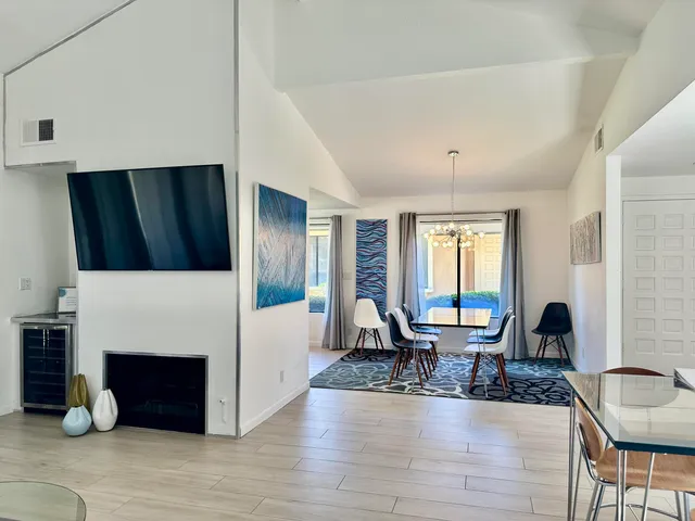 a living room with furniture a fireplace and a large window