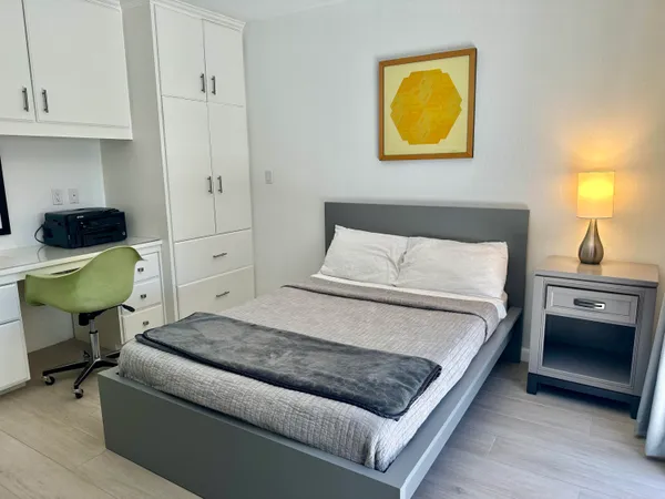 a bedroom with a bed and dresser