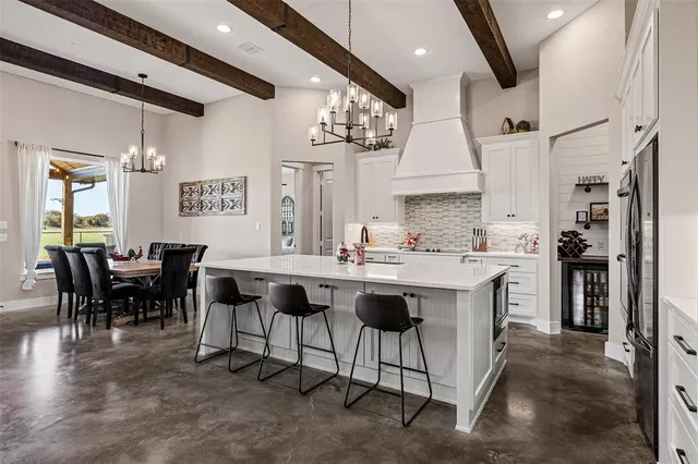 a kitchen with stainless steel appliances a refrigerator and cabinets