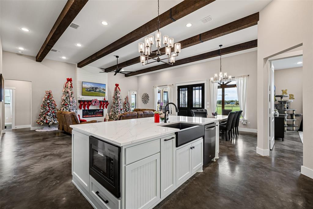 310 Runyan Rnch Road Tolar, TX 76476 - Photo 15 of 40 a kitchen with stainless steel appliances kitchen island granite countertop a large island in the center