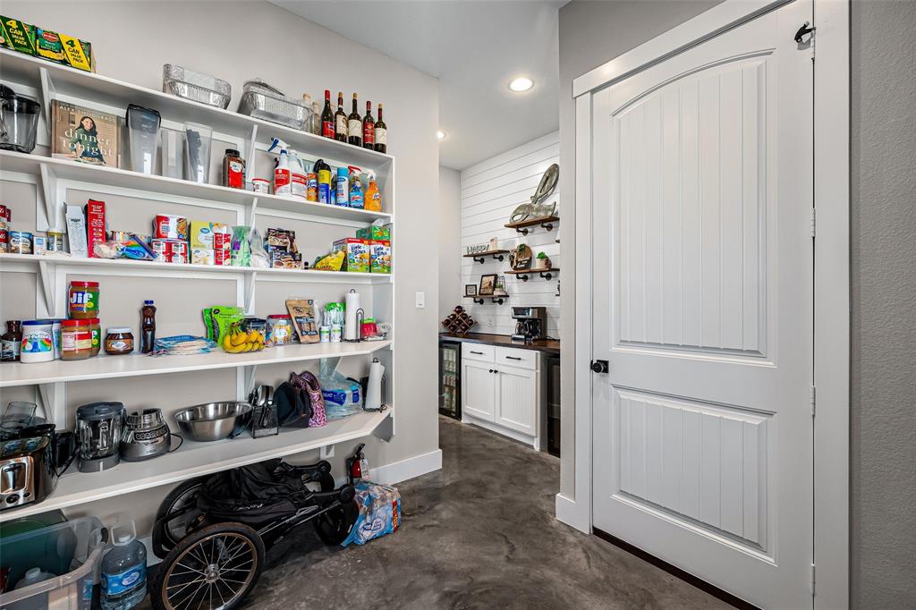 310 Runyan Rnch Road Tolar, TX 76476 - Photo 17 of 40 a room with a refrigerator and lots of clutter