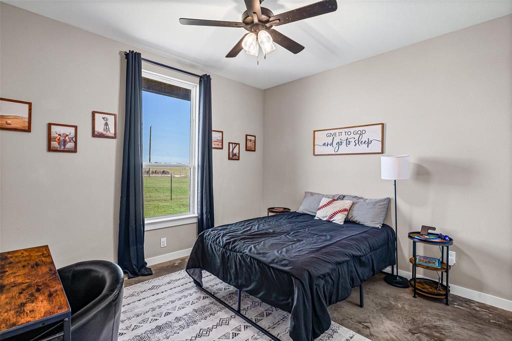 310 Runyan Rnch Road Tolar, TX 76476 - Photo 27 of 40 a bedroom with a bed and ceiling fan