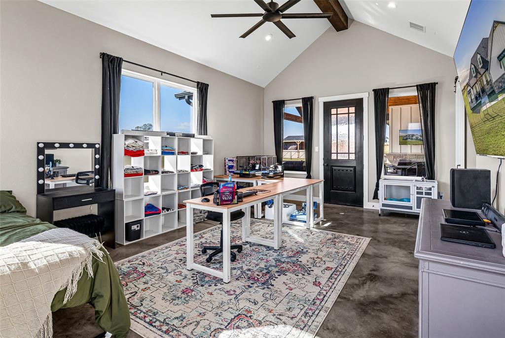 310 Runyan Rnch Road Tolar, TX 76476 - Photo 29 of 40 a living room with furniture a flat screen tv and a table