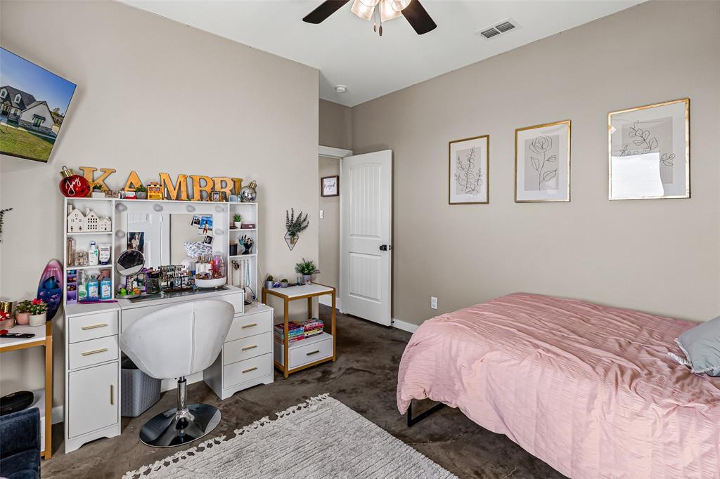 310 Runyan Rnch Road Tolar, TX 76476 - Photo 30 of 40 a bedroom with a bed and a chandelier