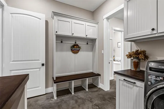 a bathroom with a granite countertop sink mirror vanity and toilet