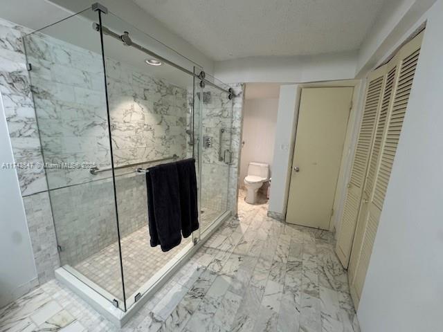 6423 Collins Avenue, Unit 809 Miami Beach, FL 33141 - Photo 12 of 18 a bathroom with a shower and a toilet