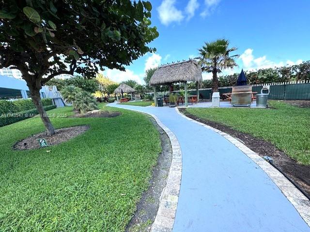 6423 Collins Avenue, Unit 809 Miami Beach, FL 33141 - Photo 17 of 18 a view of a garden with a table and chairs under an umbrella