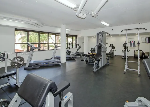a room with gym equipment and a large window
