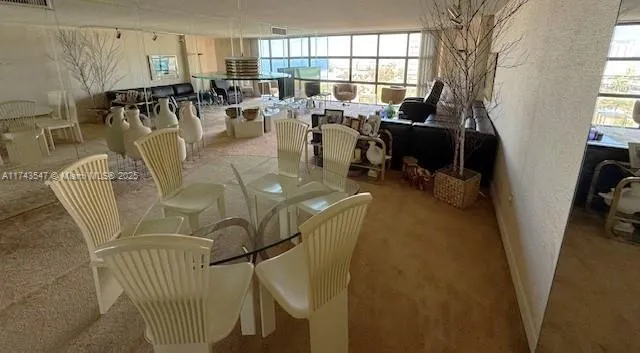 a living room with lots of chairs and a chandelier