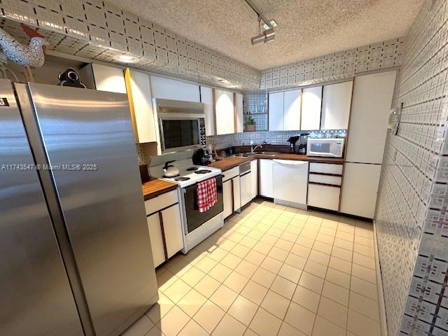 6423 Collins Avenue, Unit 809 Miami Beach, FL 33141 - Photo 6 of 18 a kitchen with stainless steel appliances a stove a sink and a refrigerator