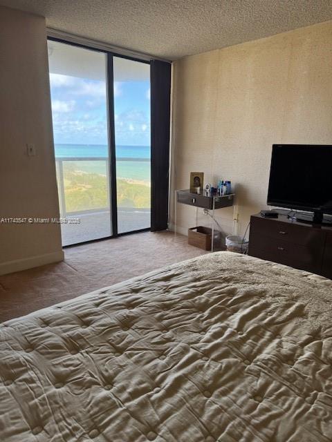 6423 Collins Avenue, Unit 809 Miami Beach, FL 33141 - Photo 8 of 18 a bedroom with a bed and a flat tv screen next to a large window