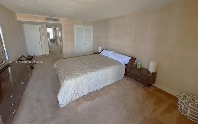 a bedroom with a bed and lamp