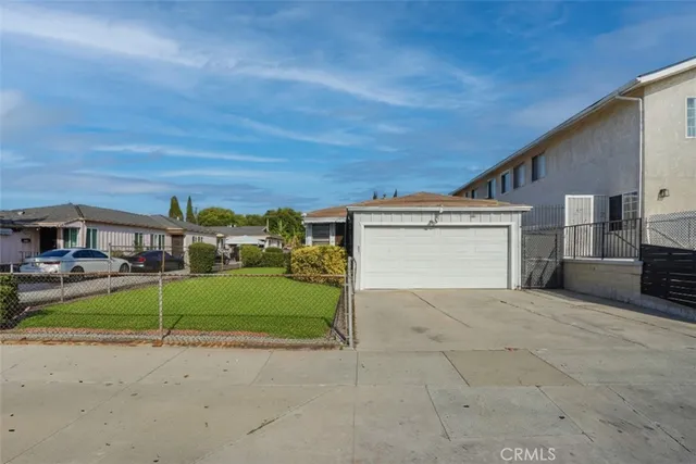 a view of a house with a yard and garage