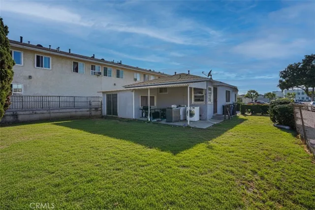 a view of a house with a backyard and a patio