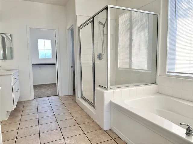 a spacious bathroom with a double vanity sink mirror and double