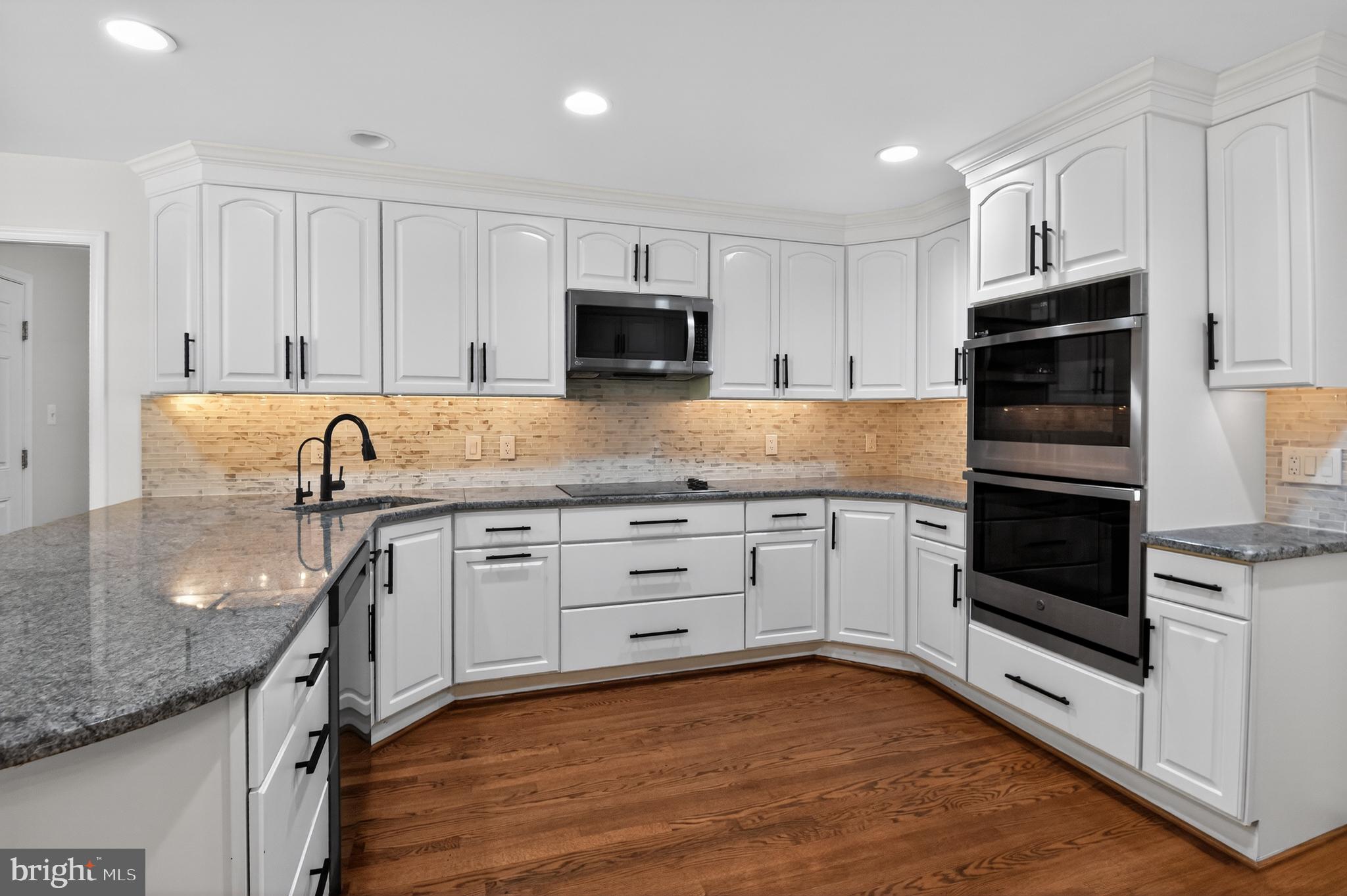 11728 Stuart Mill Road Oakton, VA 22124 - Photo 8 of 68 Sleek modern kitchen with elegant finishes.