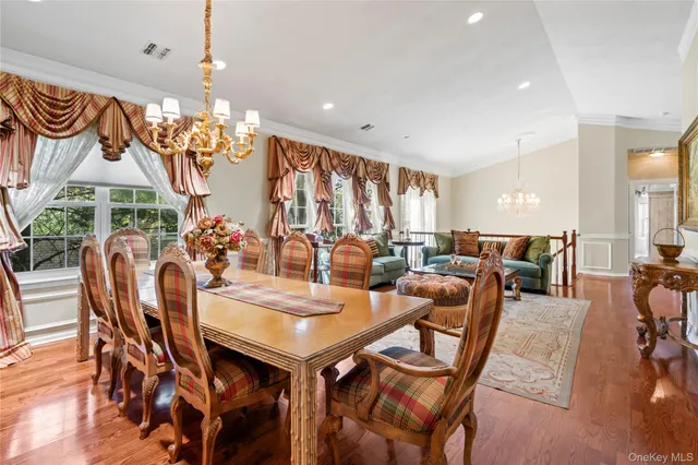 a view of a dining room with furniture and chandelier