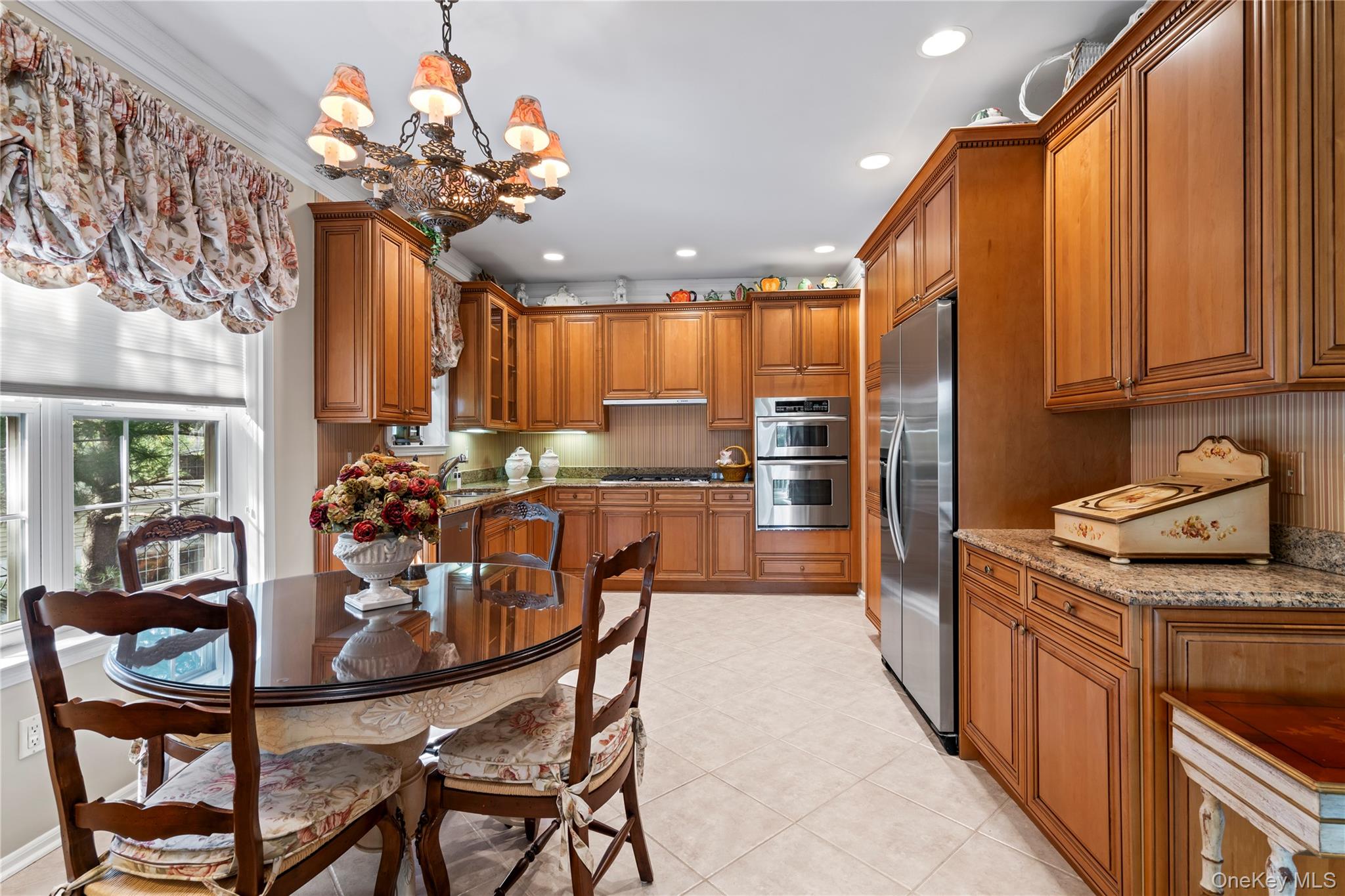 30 Sagamore Drive Plainview, NY 11803 - Photo 12 of 33 a kitchen with a dining table chairs stainless steel appliances and cabinets
