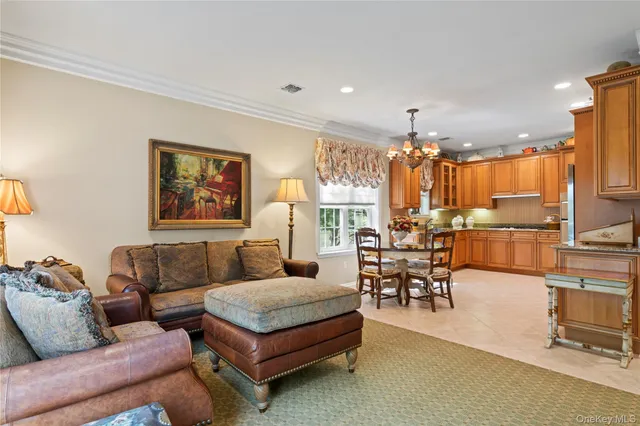 a living room with furniture and a kitchen view