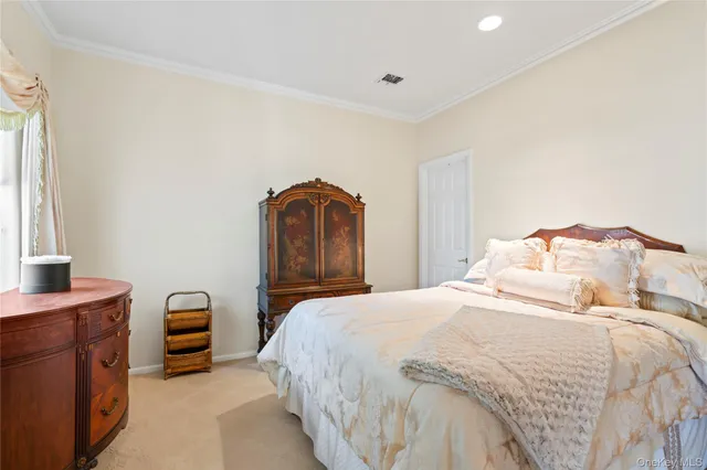 a bedroom with a bed and a potted plant