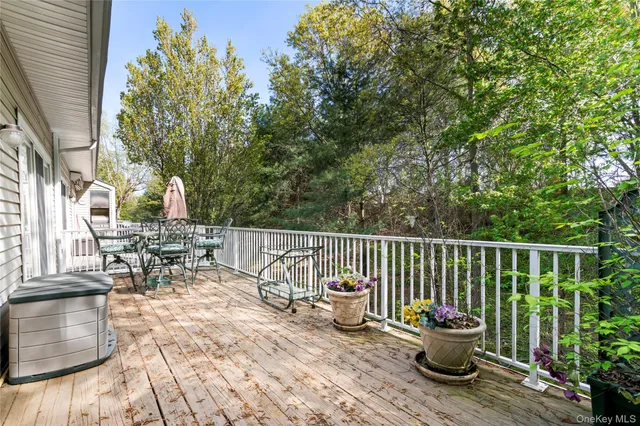 a view of balcony with two chairs and wooden fence