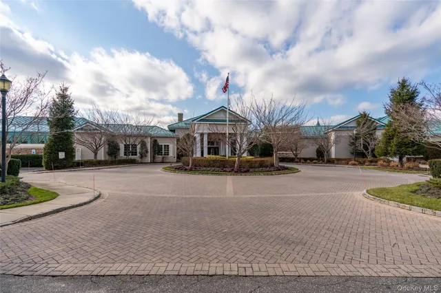 a front view of a house with a garden and pathway