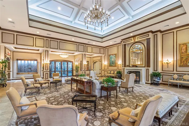 a living room with fireplace furniture and a large window