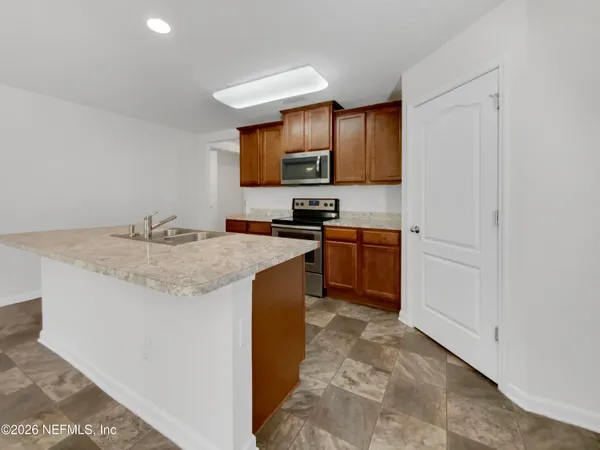 a kitchen with stainless steel appliances granite countertop a sink stove and cabinets