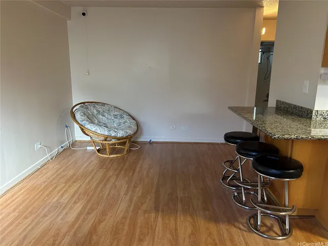 a view of a room with wooden floor and chairs