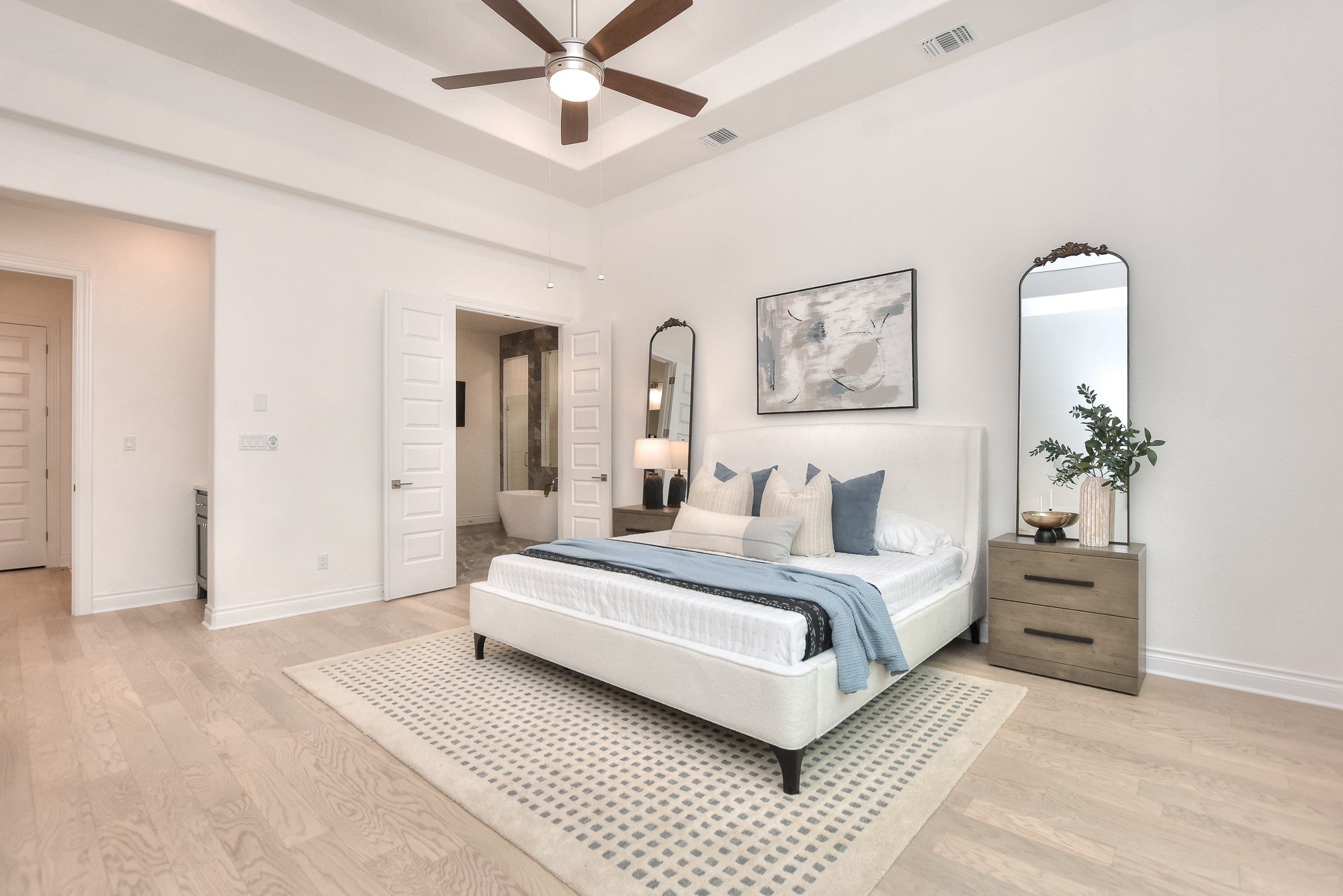 309 Wolf Rdg Road Georgetown, TX 78628 - Photo 16 of 39 Bedroom featuring ensuite bathroom, light wood finished floors, a raised ceiling, and a ceiling fan