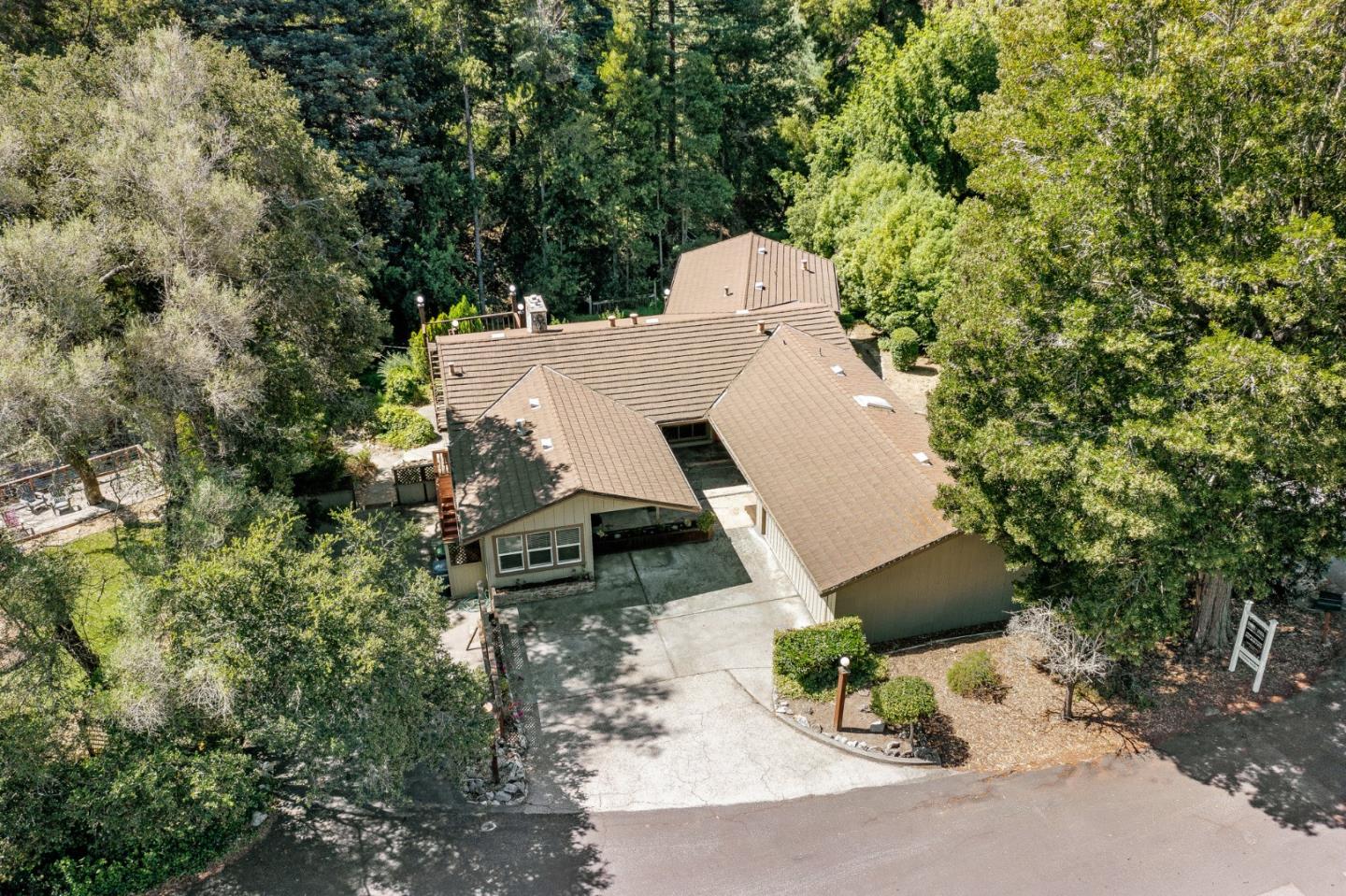 an aerial view of a house with yard and mountain view