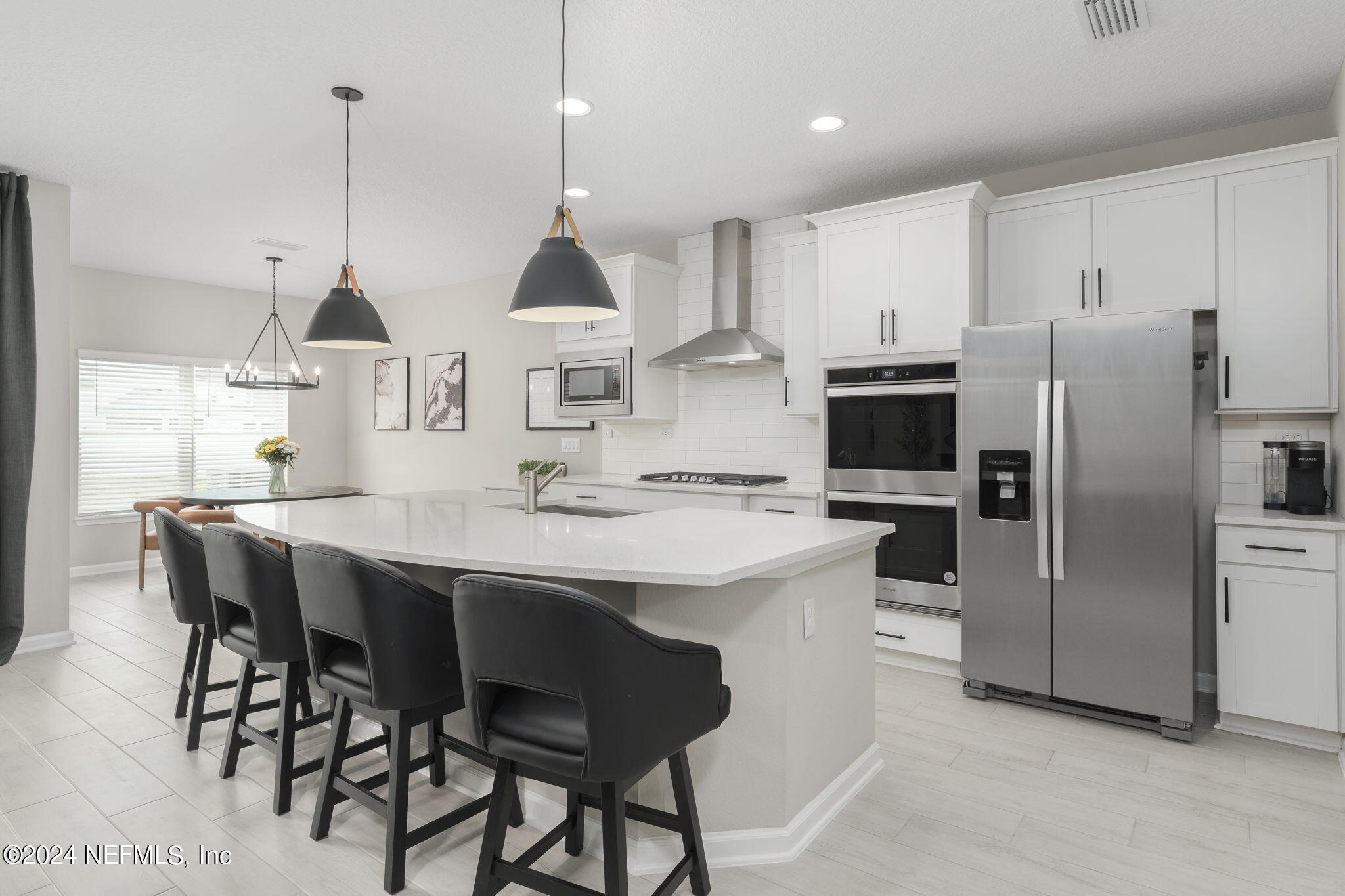33 Pinzon Pl Street St. Augustine, FL 32095 - Photo 15 of 41 a kitchen with stainless steel appliances kitchen island granite countertop a sink a stove a refrigerator and island with wooden floor