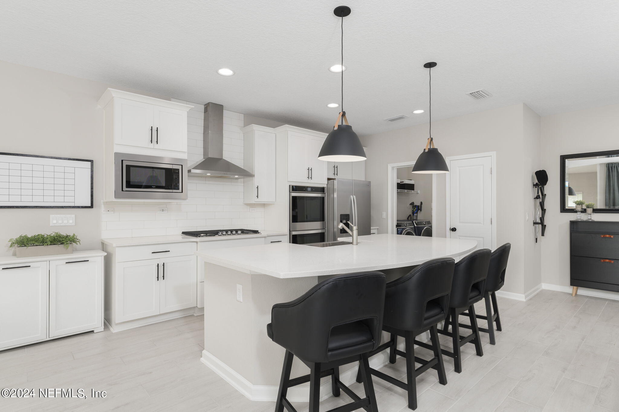 33 Pinzon Pl Street St. Augustine, FL 32095 - Photo 16 of 41 a kitchen with stainless steel appliances granite countertop a stove a sink a oven a dining table and chairs