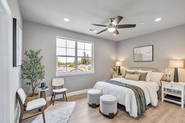 a bedroom with a bed and a chair