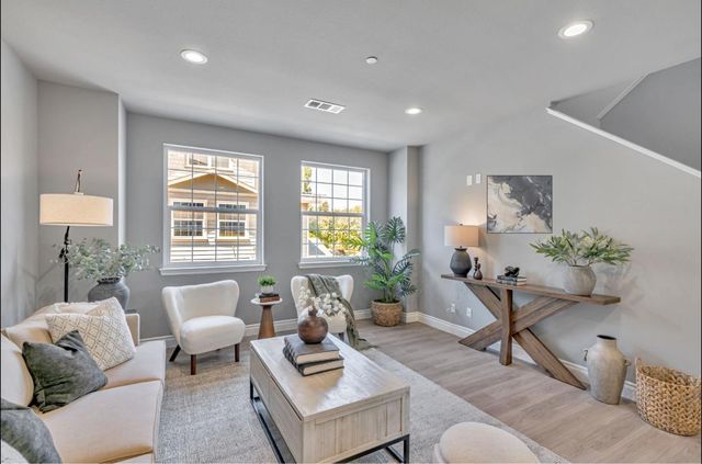 a living room with furniture and a potted plant