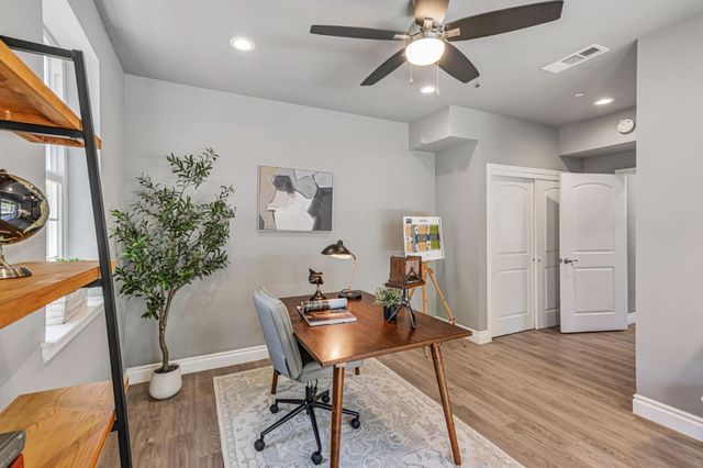 a view of a workspace with furniture and a kitchen