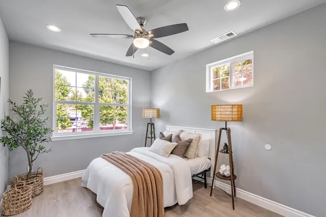 a bedroom with a bed and a potted plant