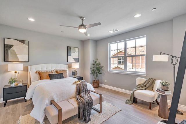 a bedroom with a bed couch and window