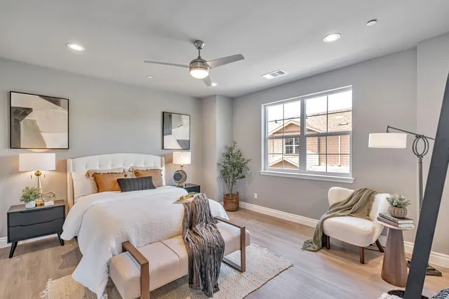 a bedroom with a bed couch and window