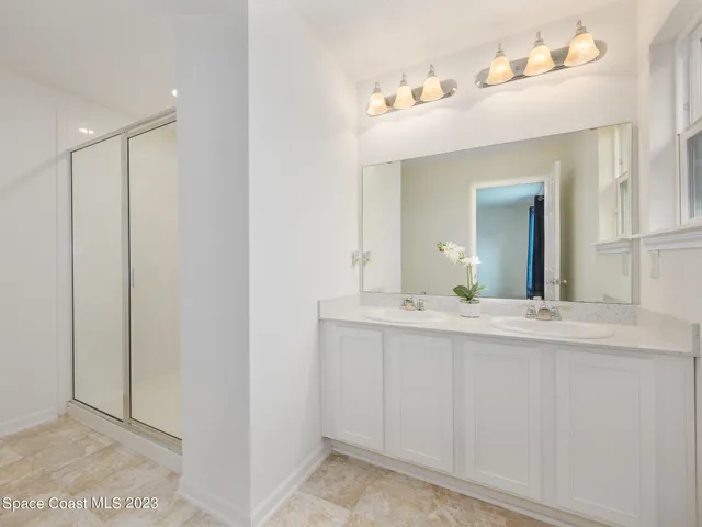 a bathroom with a granite countertop toilet and a shower